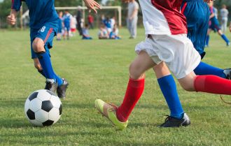 Players passing the ball into a striker playing high up the pitch