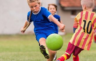 Girl shooting at goal